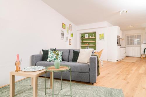 a living room with a couch and a table at Zum Grazer Uhrturm in Graz
