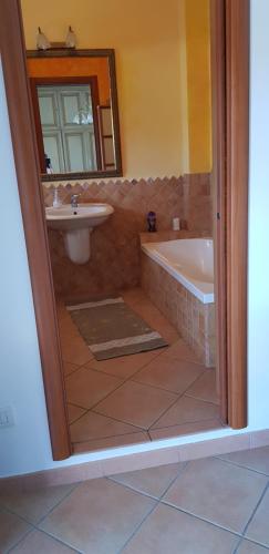 a bathroom with a bath tub and a sink at VelaLatina in Stintino