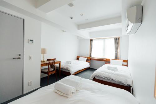 Postel nebo postele na pokoji v ubytování KéFU stay & lounge
