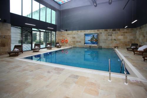 a large swimming pool in a large building at Crowne Plaza Istanbul Oryapark by IHG in Istanbul