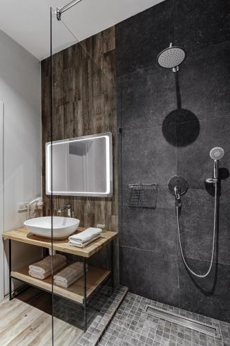 a bathroom with a shower with a sink and a mirror at WELCOME summer in Zatoka