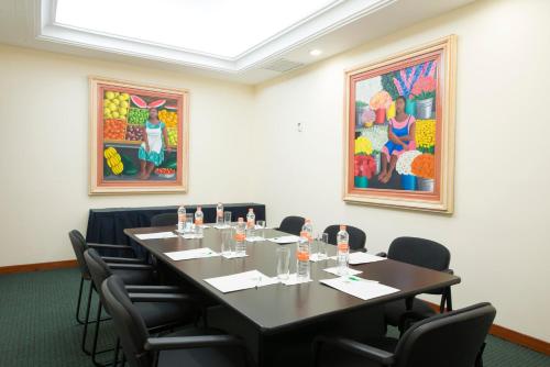 a conference room with a table and chairs at Holiday Inn Merida by IHG in Mérida