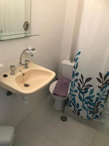 a bathroom with a sink and a toilet at Pansion Angela in Skiathos Town