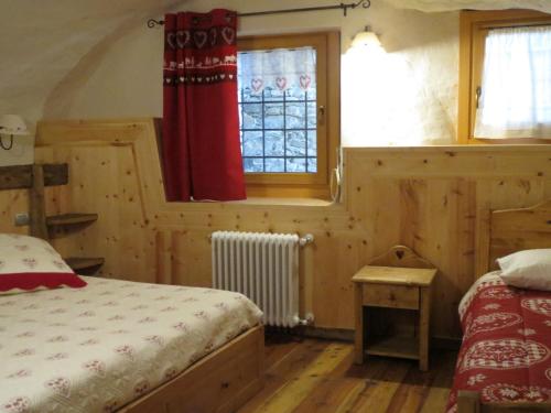 a bedroom with two beds and a window at Maison Peroulaz in Charvensod