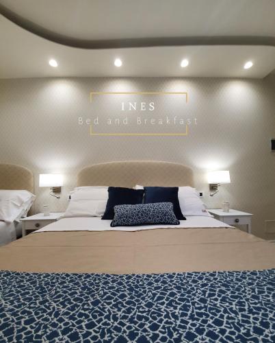 a bedroom with a large bed with a blue and white blanket at Ines bed and breakfast in Giardini Naxos