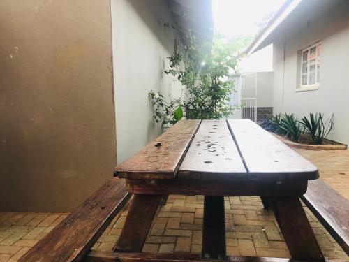 einem Holztisch inmitten einer Terrasse in der Unterkunft La Benroy in Klerksdorp