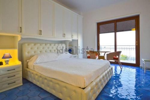 a bedroom with a large bed and a table and chairs at Luxury Apartment Amalfi in Amalfi