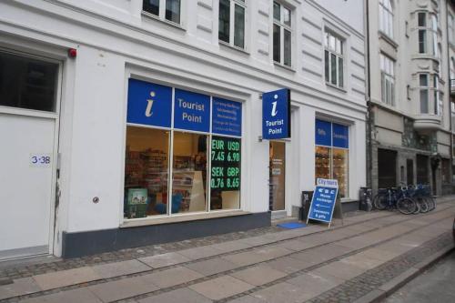 a store with blue signs on the side of a street at Exquisite apartment, most convenient location, Apt 5. in Copenhagen