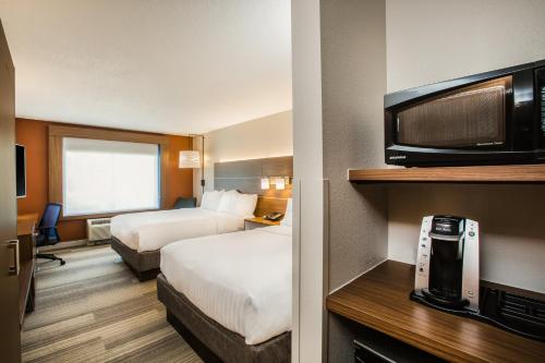 a hotel room with two beds and a flat screen tv at Holiday Inn Express Hotel & Suites Bellevue-Omaha Area, an IHG Hotel in Bellevue