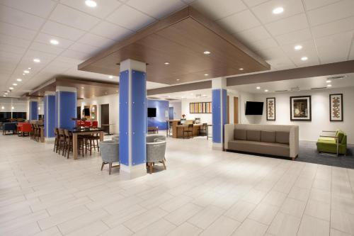 a living room filled with furniture and a tv at Holiday Inn Express & Suites - Dakota Dunes, an IHG Hotel in Dakota Dunes