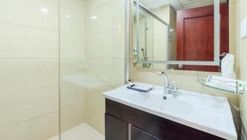 a bathroom with a sink and a shower at Attide Biz in Bangalore