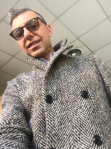 a man wearing a gray coat and sunglasses at B&B SPQR in Rome