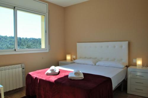 a bedroom with a bed with two towels on it at Villa Babette in Vidreres