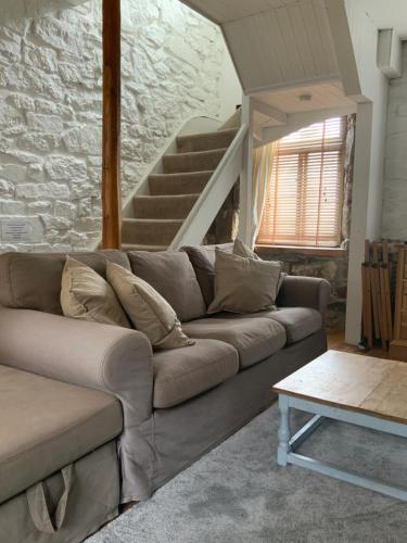 
a living room with a couch and a table at Trezise Cottage in Penzance
