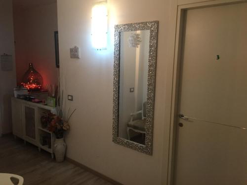 a mirror on a wall next to a door at B&B SPQR in Rome