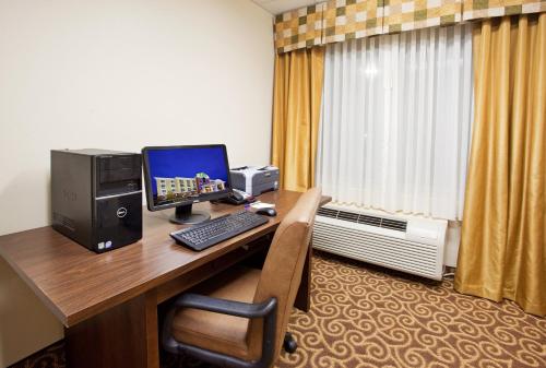 a desk with a computer on top of it at Holiday Inn Express & Suites Niagara Falls by IHG in Niagara Falls