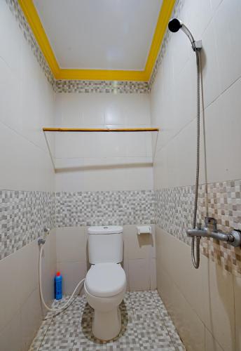 a bathroom with a white toilet in a room at Zamzam Anjani Villa Lombok in Praya