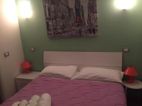 a bedroom with a bed with a purple comforter at B&B SPQR in Rome