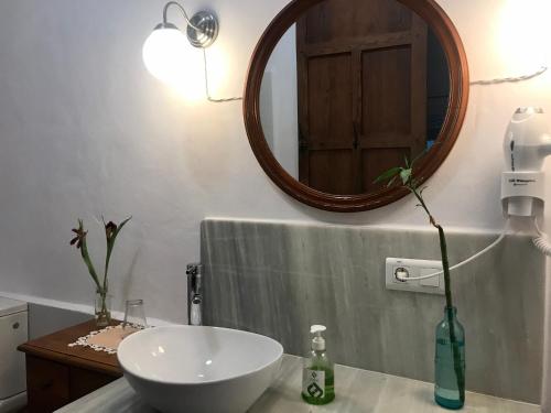 a bathroom with a white sink and a mirror at al-qandil in Margarida