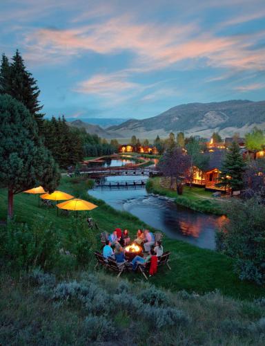 a group of people sitting in a boat on a river at Rustic Inn Creekside in Jackson