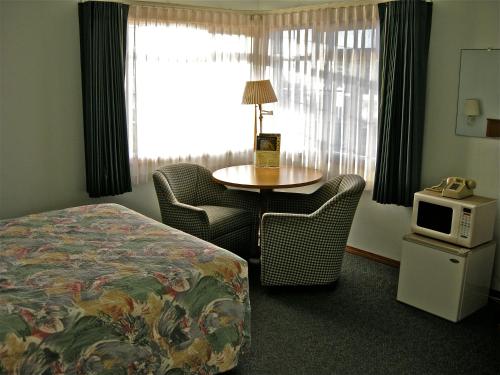 Ένα ή περισσότερα κρεβάτια σε δωμάτιο στο Azalea Lodge