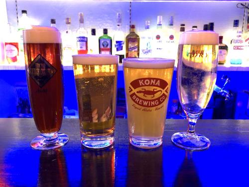 three glasses of beer sitting on a table at TOP EDGE HOSTEL Koenji in Tokyo