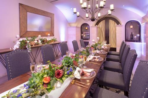 a long dining room with a long table with flowers at Crowne Plaza Costa Mesa Orange County by IHG in Costa Mesa