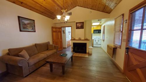 a living room with a couch and a fireplace at Kernville Inn in Kernville