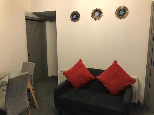 a living room with a couch and two mirrors on the wall at Jodon House in Middlesbrough