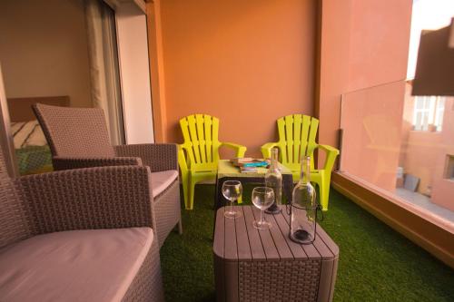 a room with chairs and a table with wine glasses at Luxury Beach Apartment - Romantic Weekend Getaway in Imi Ouaddar