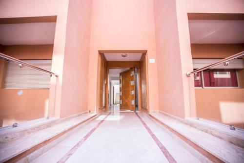 an empty corridor of an office building with a hallway at Luxury Beach Apartment - Romantic Weekend Getaway in Imi Ouaddar