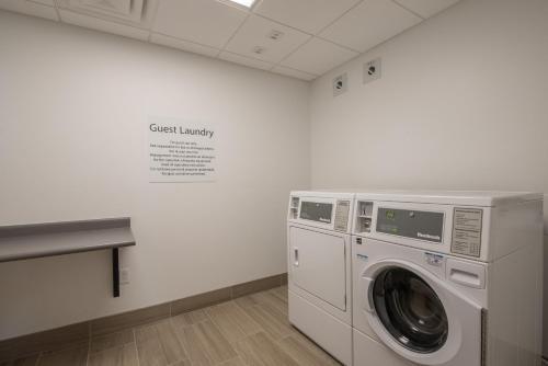 a washer and dryer in a room with a wall at Holiday Inn Express & Suites Lehi - Thanksgiving Point by IHG in Lehi