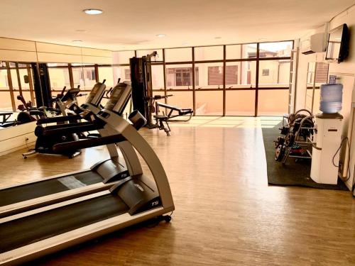 a gym with treadmills and ellipticals in a building at Jurerê Beach Village - Flat na Praia in Florianópolis