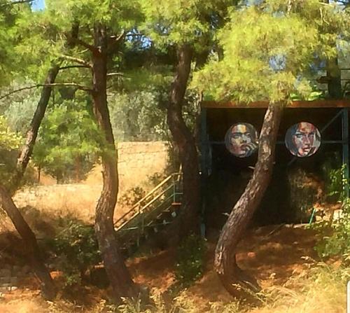 a painting of a bridge between two trees at Kazdaglari Karye Müze Hotel in Kucukkuyu