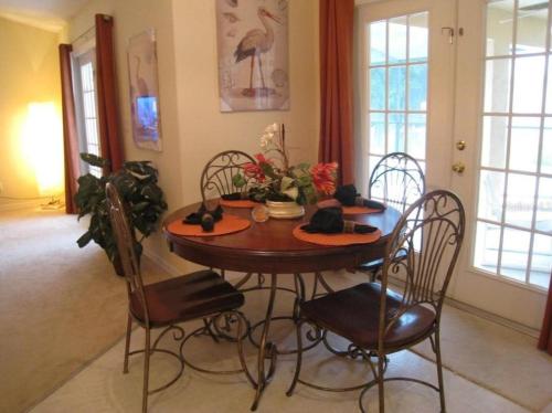 a dining room with a table and chairs at Family Vacation Home With Pool and Spa Near Disney and Universal in Orlando