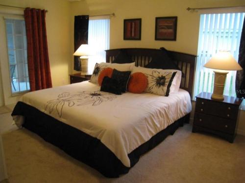 a bedroom with a large bed with pillows on it at Family Vacation Home With Pool and Spa Near Disney and Universal in Orlando