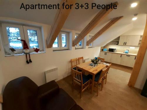 a kitchen and dining room with a table and chairs at Apartmány pod Mariánskými schody in Albrechtice v Jizerských horách