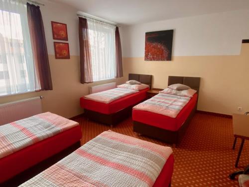 a room with three beds in a room at Eurostopas in Bremen