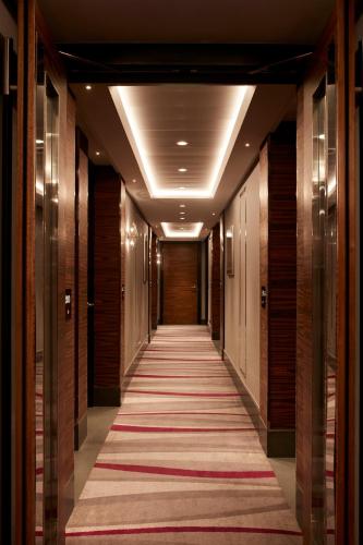 a hallway of a hotel with a carpet on the floor at Hyatt Regency London Albert Embankment in London