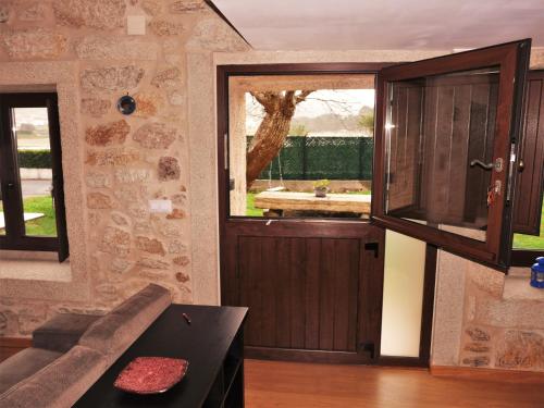 a living room with a door and a window at Apartamento Rural Sorribos (VUT-CO-004306) in Muros