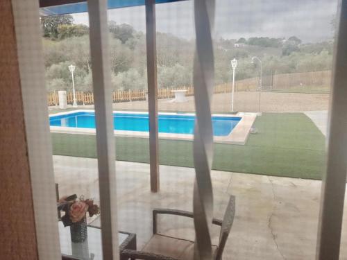 a view of a swimming pool from a window at Casa con piscina de agua salada Villa Pepucho 1 in Córdoba