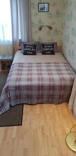 a bedroom with a bed with two pillows on it at Grafovi Apartments in Narva