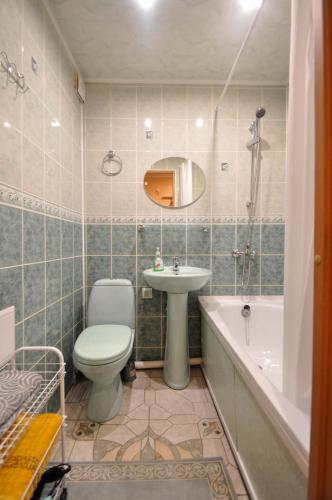 a bathroom with a toilet and a sink and a tub at Grafovi Apartments in Narva
