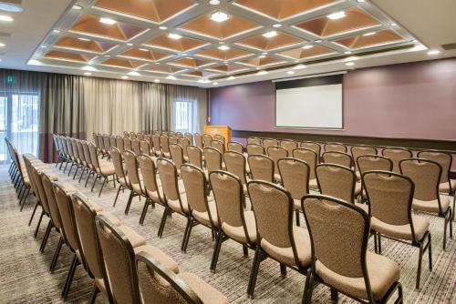 a row of chairs in a room with a screen at Crowne Plaza Kitchener-Waterloo by IHG in Kitchener