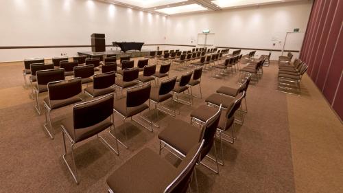 an empty room with chairs and a podium in it at Holiday Inn Mexico City-Plaza Universidad by IHG in Mexico City
