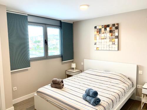 En eller flere senge i et værelse på appartement Duna Beach