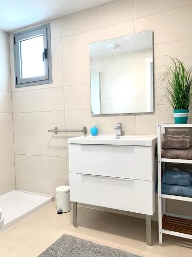 a bathroom with a white sink and a mirror at appartement Duna Beach in Torrox Costa