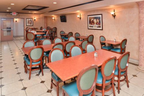 a room with tables and chairs in a restaurant at Holiday Inn Rancho Cordova - Northeast Sacramento by IHG in Rancho Cordova