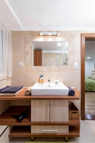 a bathroom with a sink and a mirror at Moon Stone Residence Pag in Pag