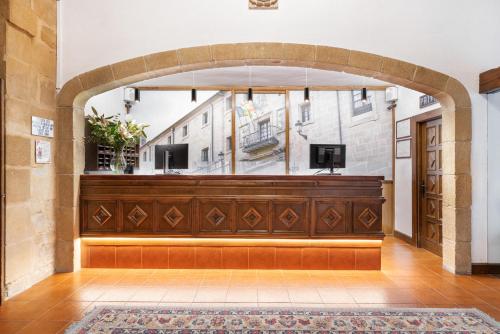 a large room with an archway with a court sidx sidx at Eurostars Los Agustinos in Haro